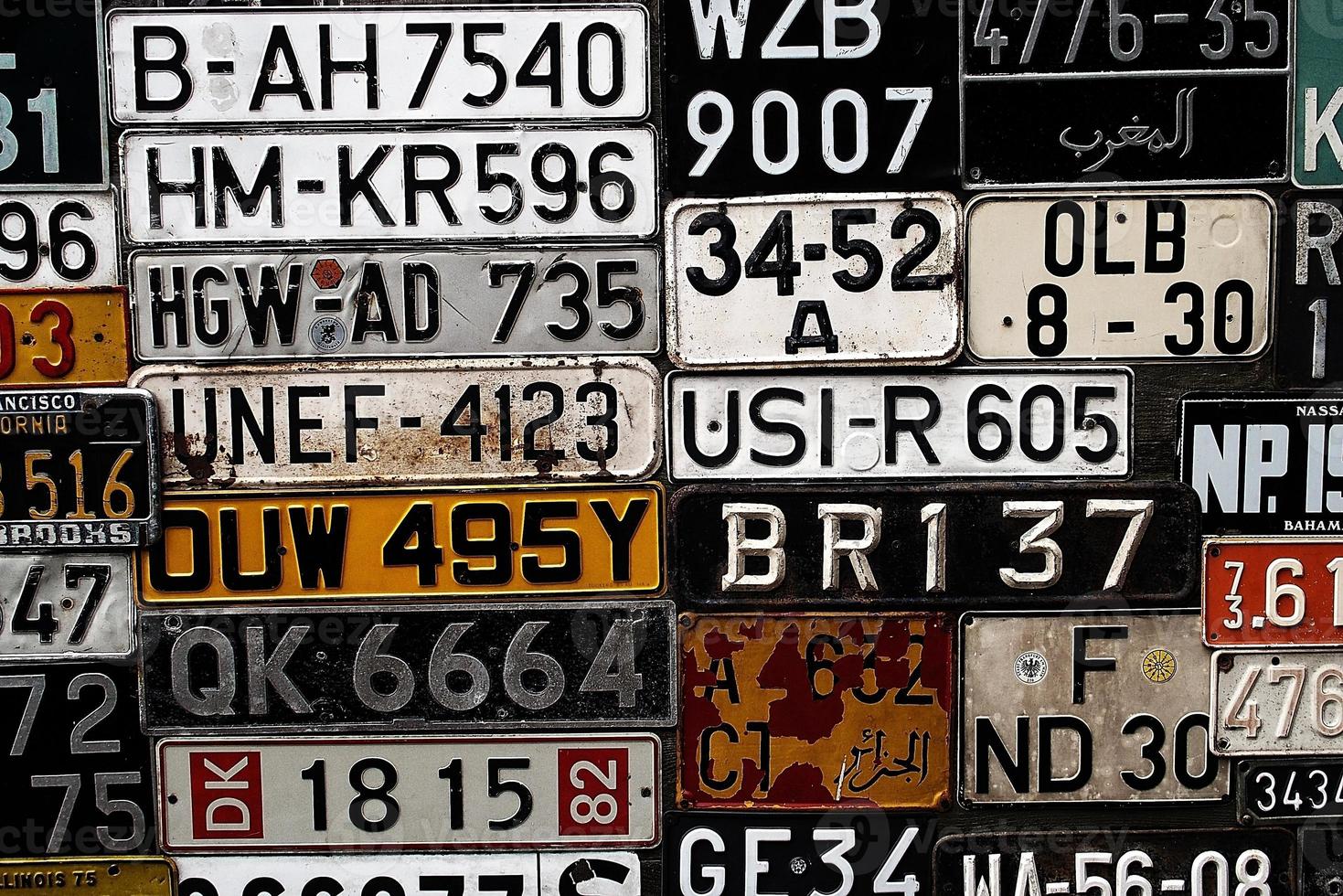 Various old car license plates from around the world at the museum photo