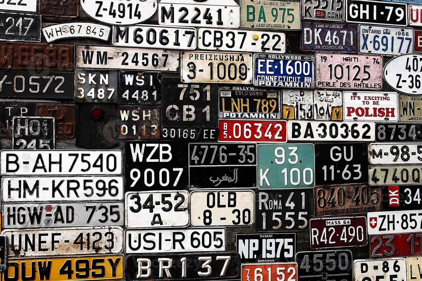 Various old car license plates from around the world at the museum photo