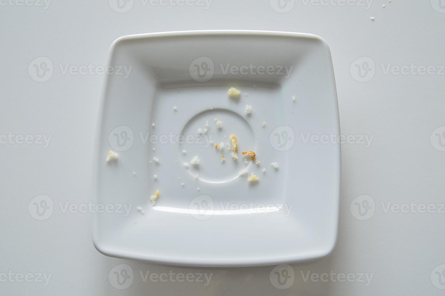 empty small square telekrzyk with crumbs after eating on a white background photo