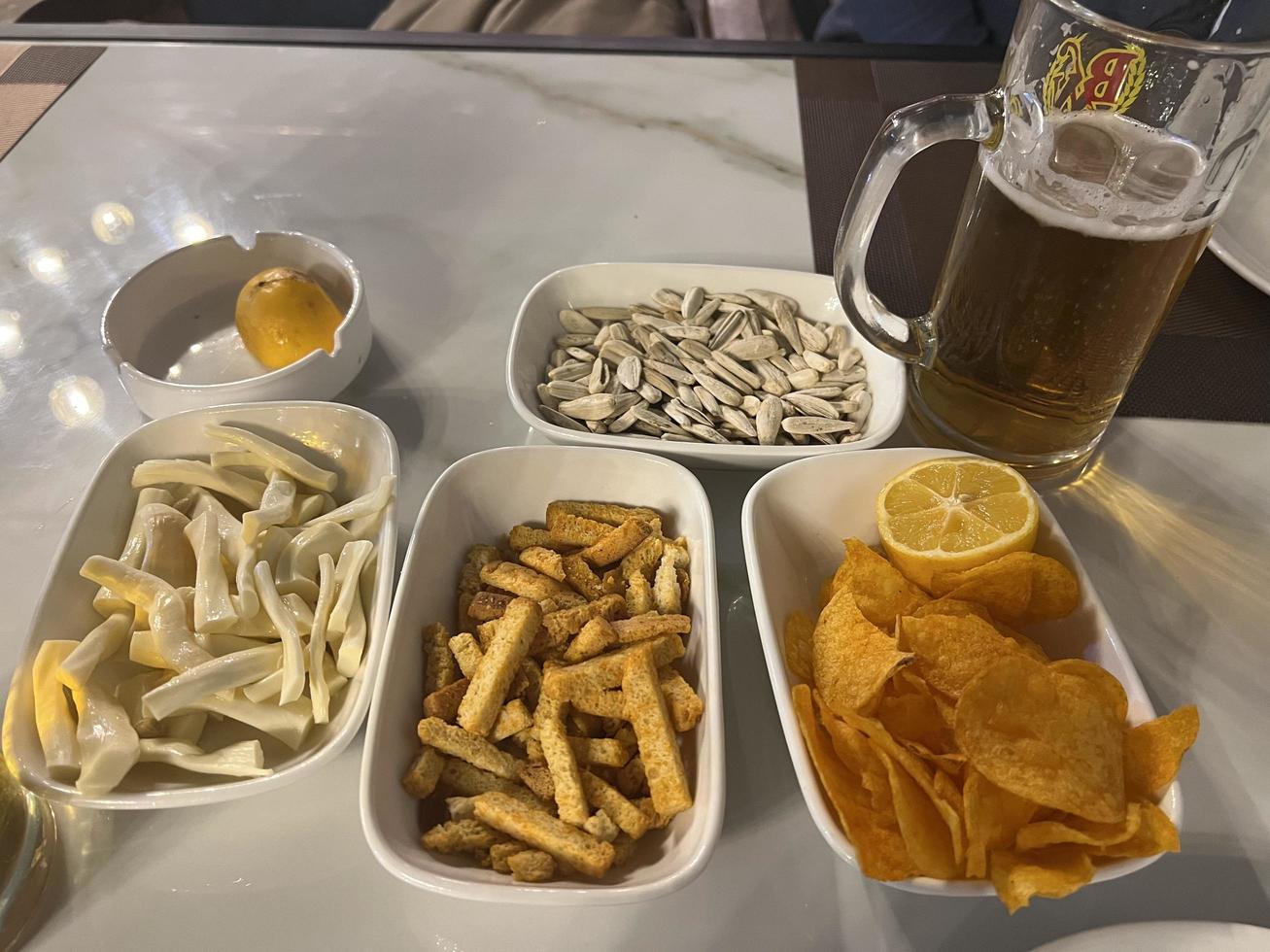 Snacks and beer on the table in a pub. Close up photo