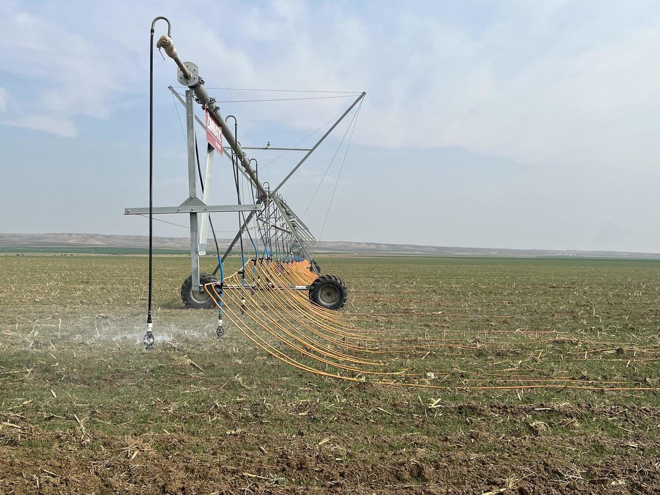 Irrigation system watering the field with a high pressure water jet photo