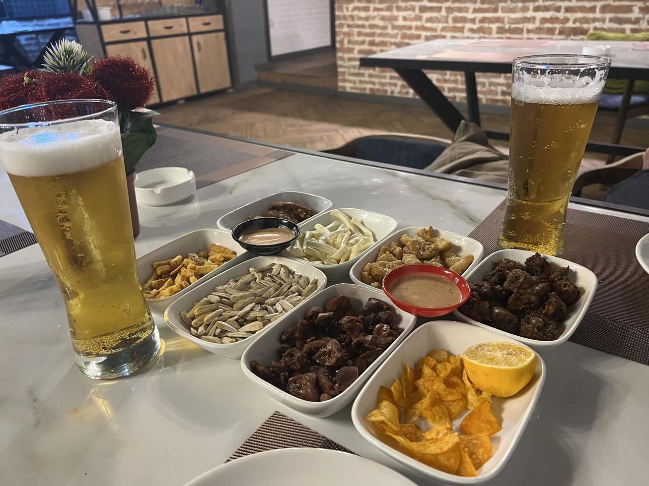 Snacks and beer on the table in a pub. Close up photo