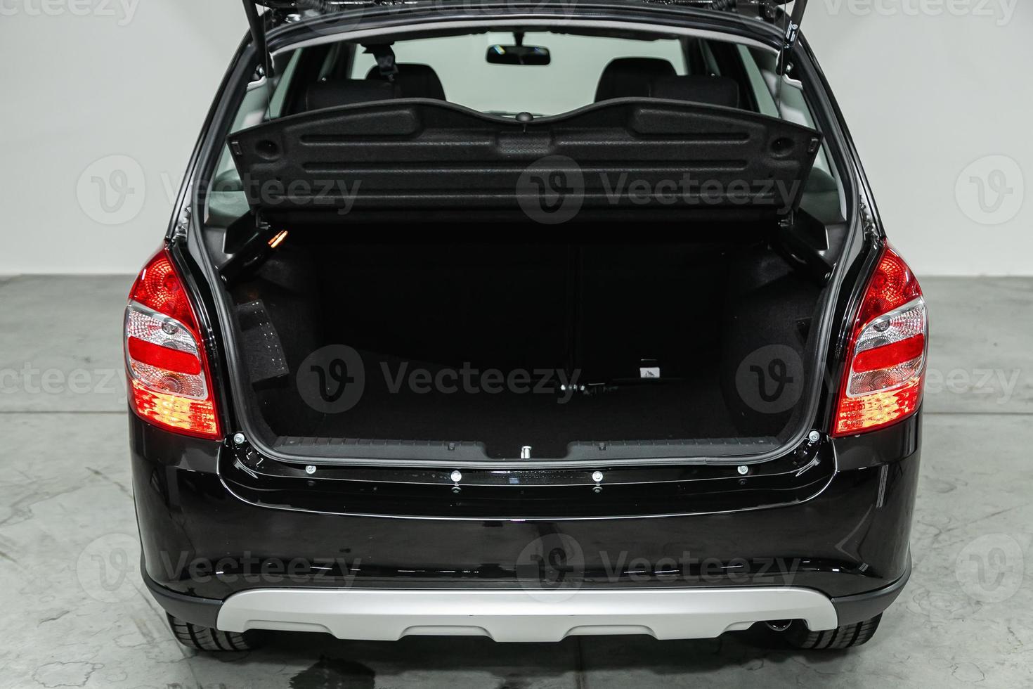 close up of the open trunk, headlight, bumper,  front view. photo