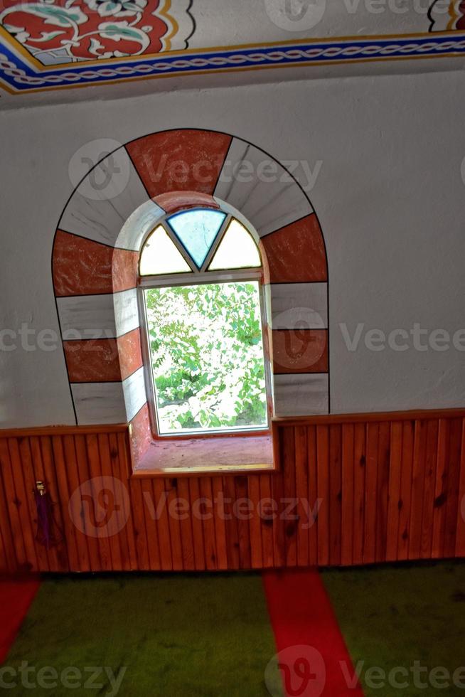 modest simple interior of a small Turkish village mosque with one miner photo