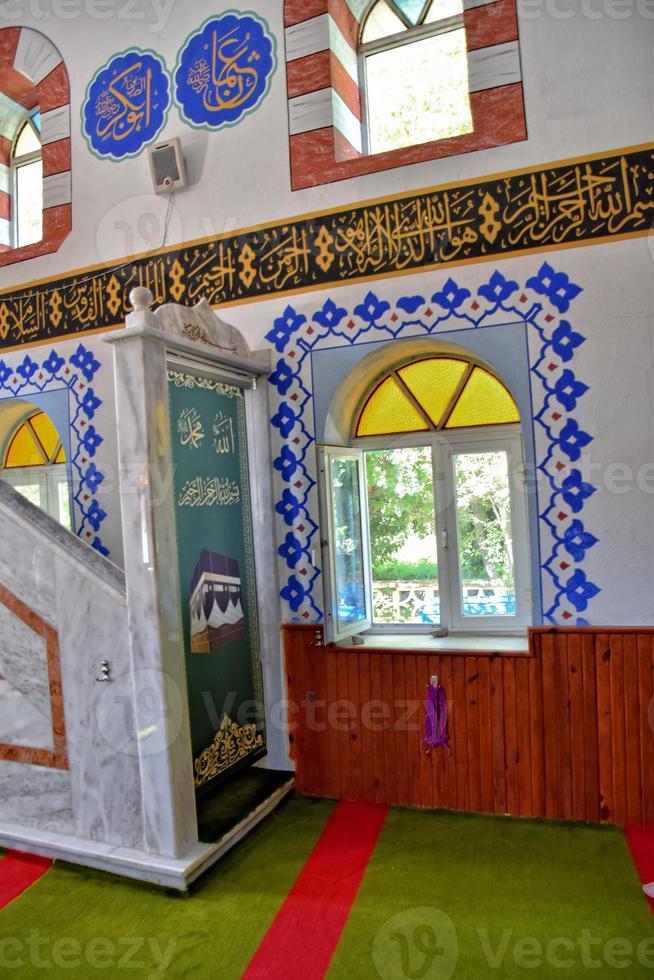 modest simple interior of a small Turkish village mosque with one miner photo