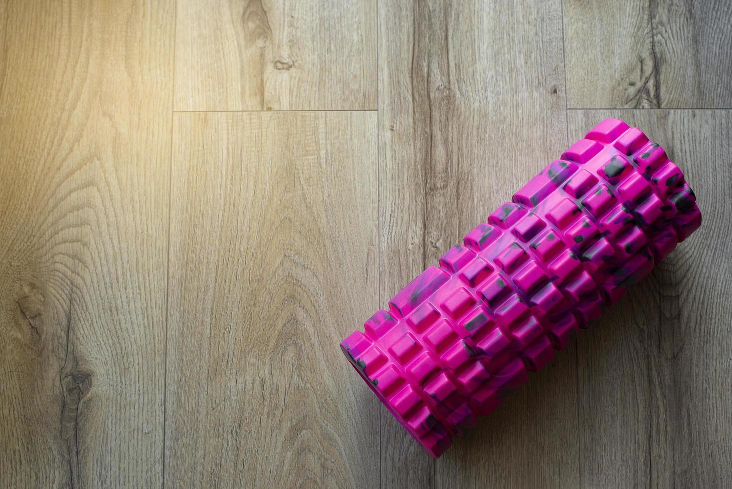 Pink foam roller with spikes. Myofascial release. Massage. Massager. photo