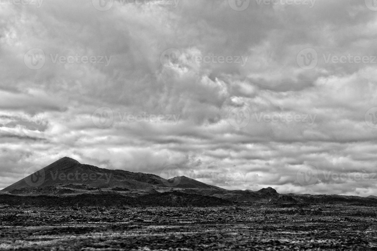 empty mysterious mountainous landscape from the center of the Canary Island Spanish Fuerteventura with a cloudy sky photo