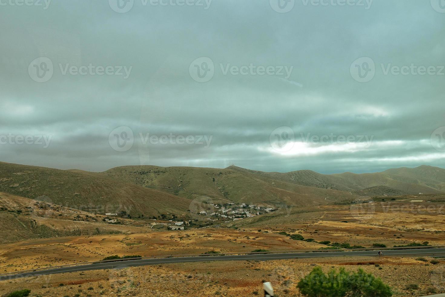 empty mysterious mountainous landscape from the center of the Canary Island Spanish Fuerteventura with a cloudy sky photo