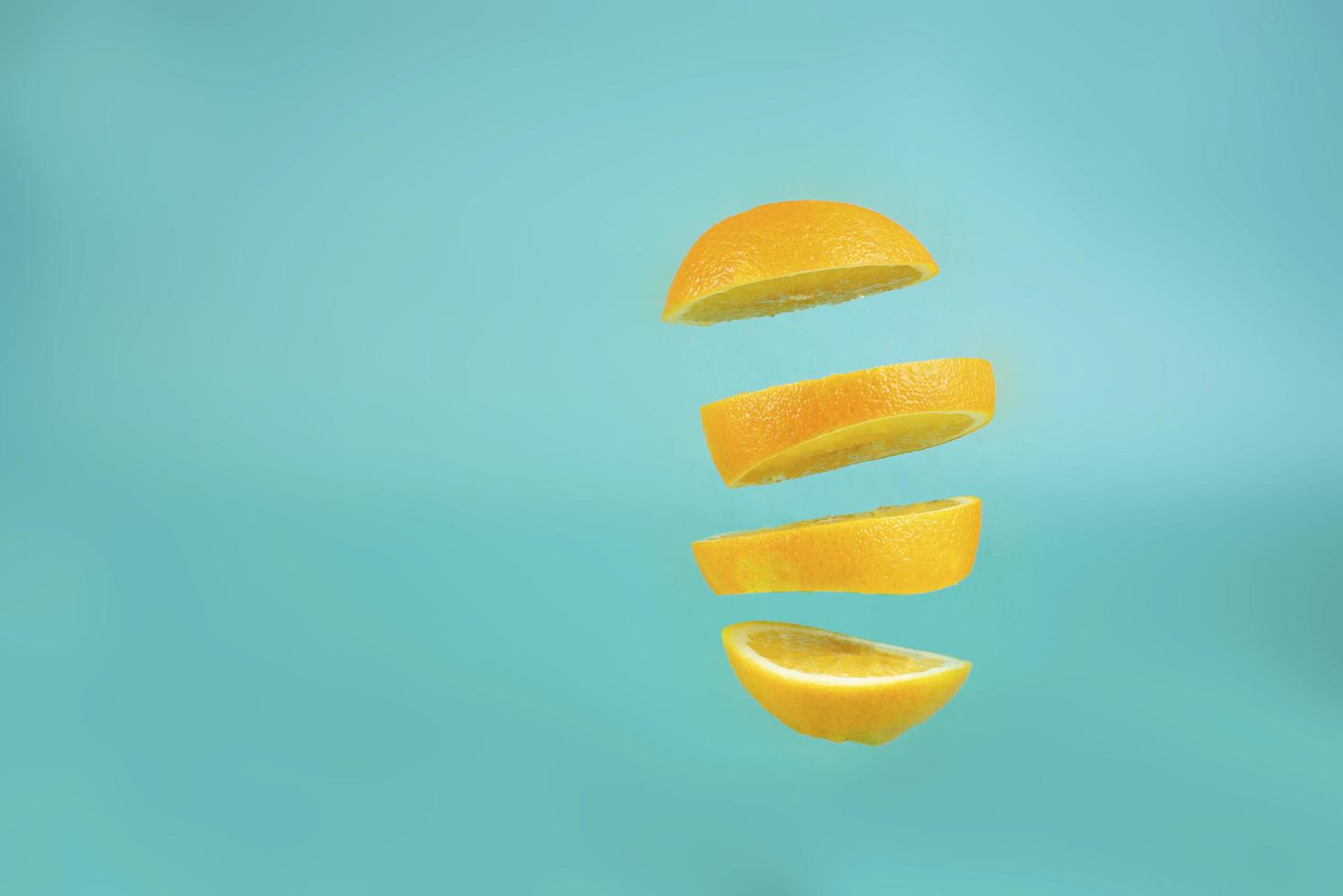 levitating cuted orange orange on blue background photo