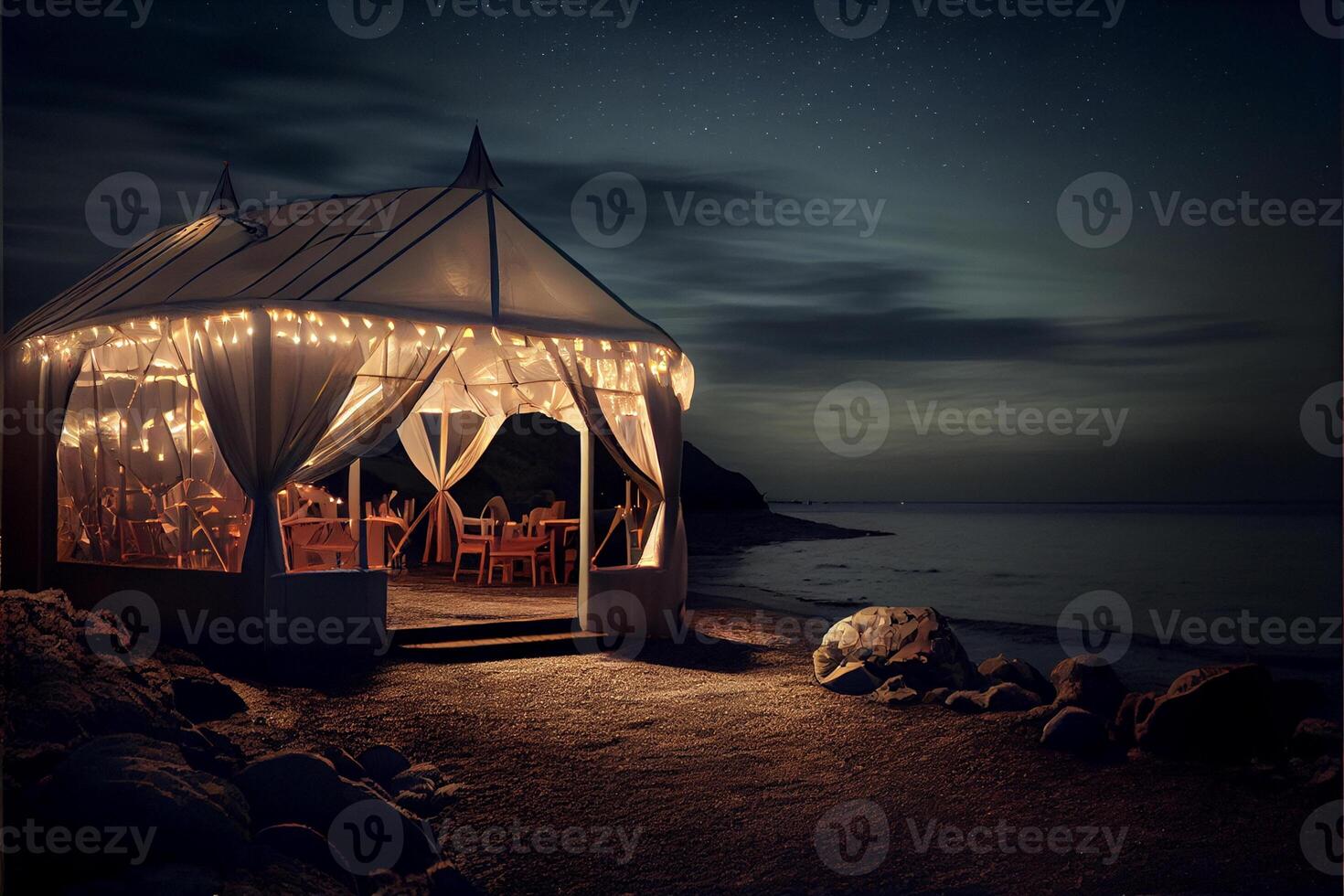 gazebo sitting on top of a beach next to the ocean. . photo