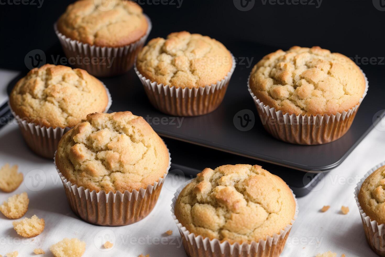 Homemade muffins with cinnamon and almonds on a black background. photo