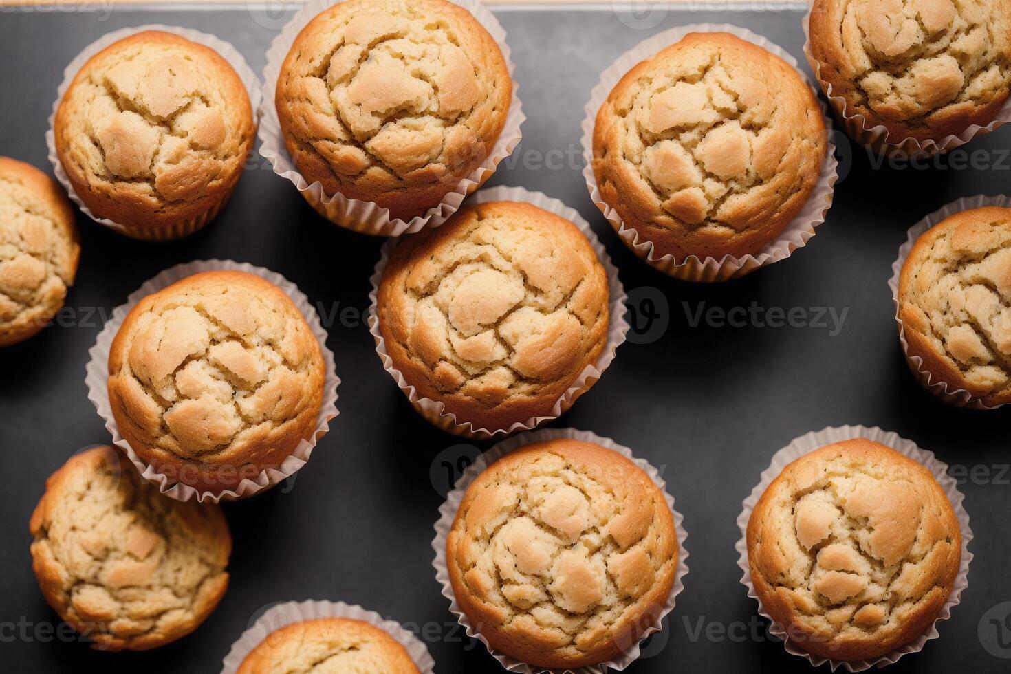 Homemade muffins with cinnamon and almonds on a black background. photo