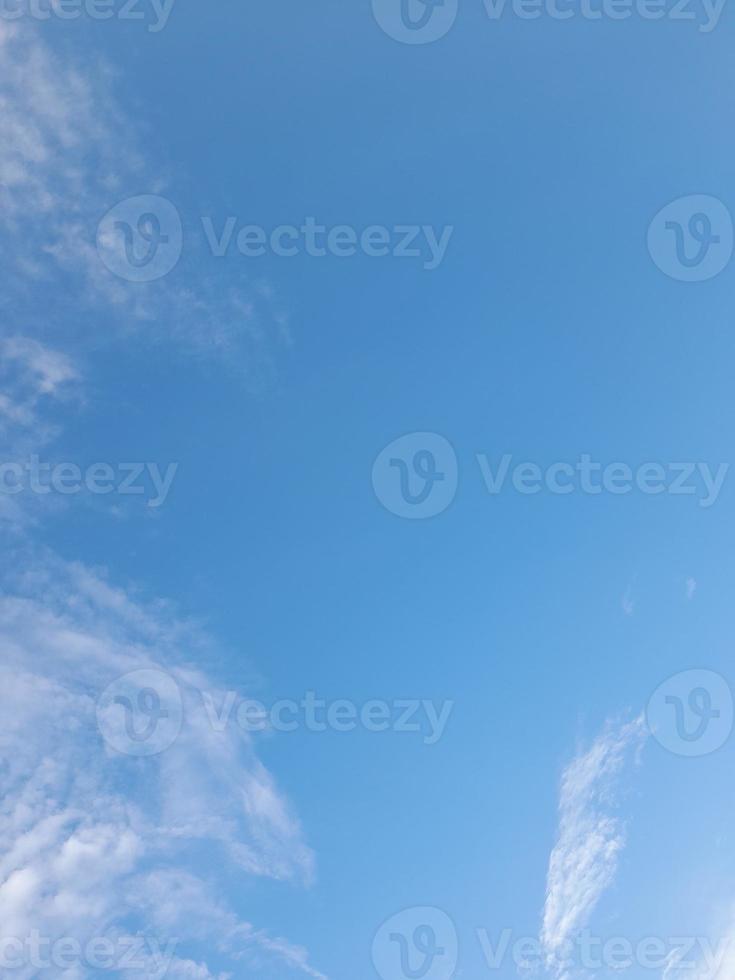 Beautiful white clouds on deep blue sky background. Large bright soft fluffy clouds are cover the entire blue sky. photo