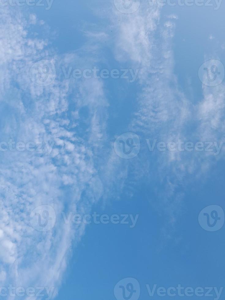 Beautiful white clouds on deep blue sky background. Large bright soft fluffy clouds are cover the entire blue sky. photo