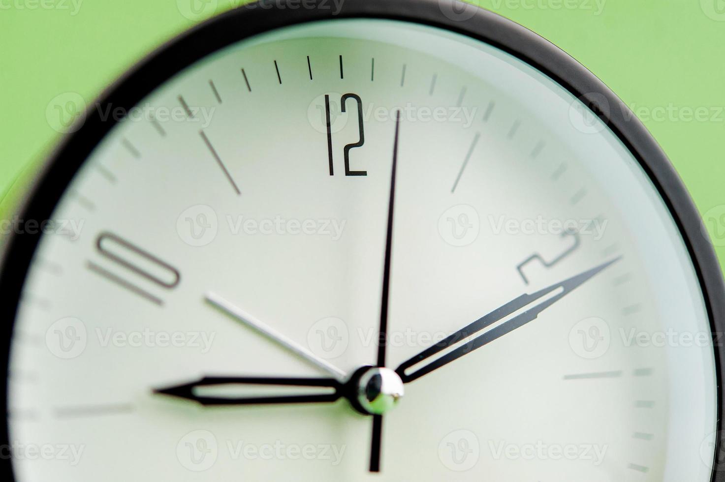 alarm clock on green background time concept working with time precious time photo