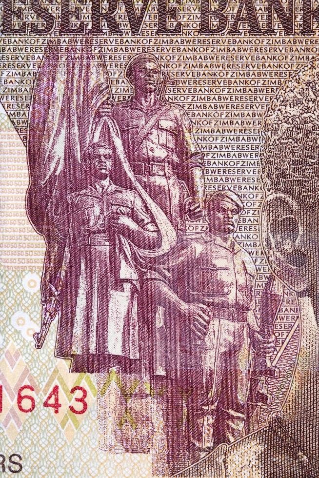 Three armed men with a banner from Zimbabwean money photo