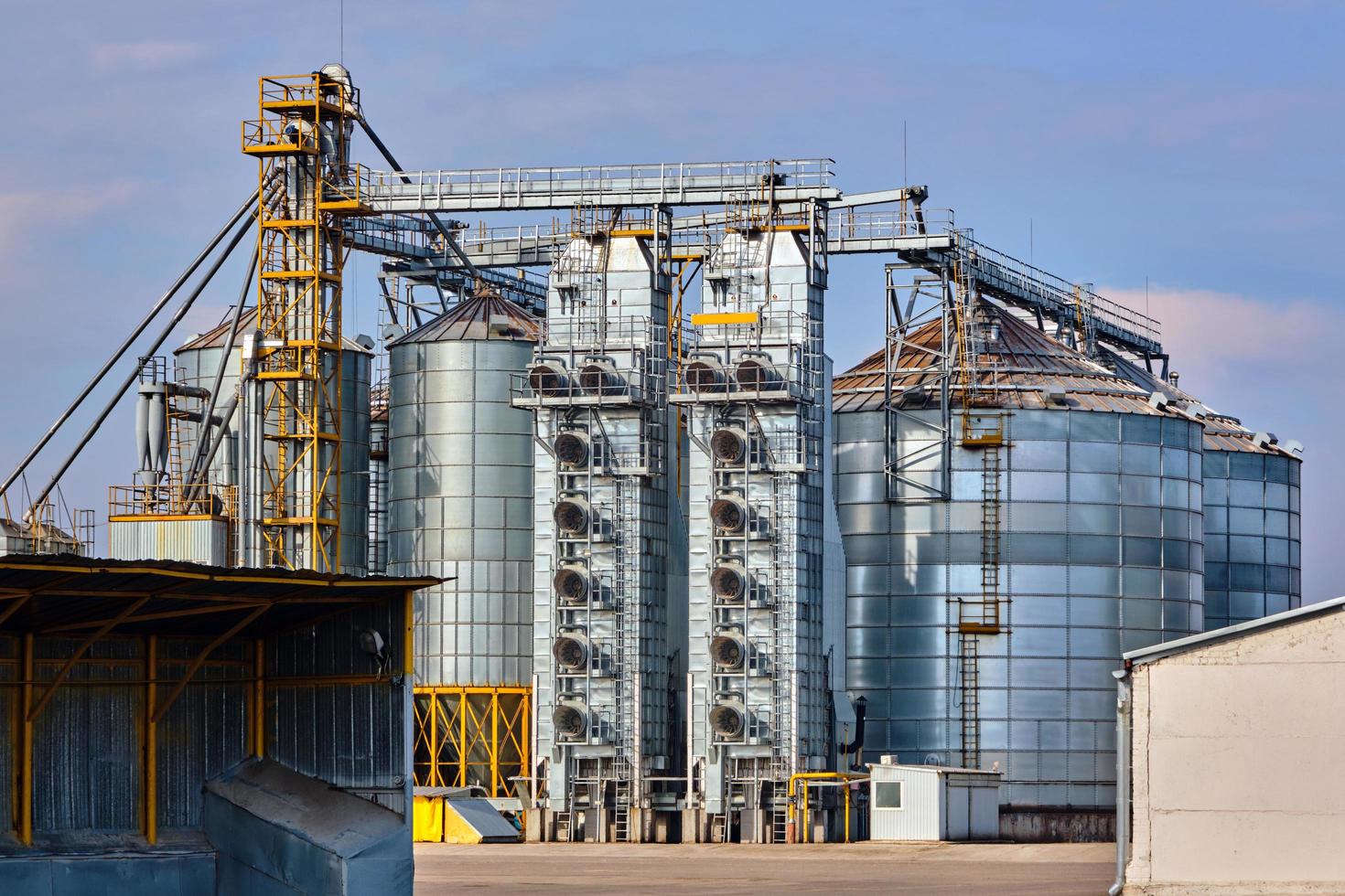 agro silos on agro-industrial complex and grain drying and seeds cleaning line. photo