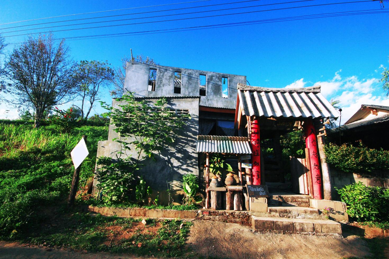 Yunnan Chinese hilltribe houses on the mountain with beautiful blue sky and sunlight in northern Thailand photo