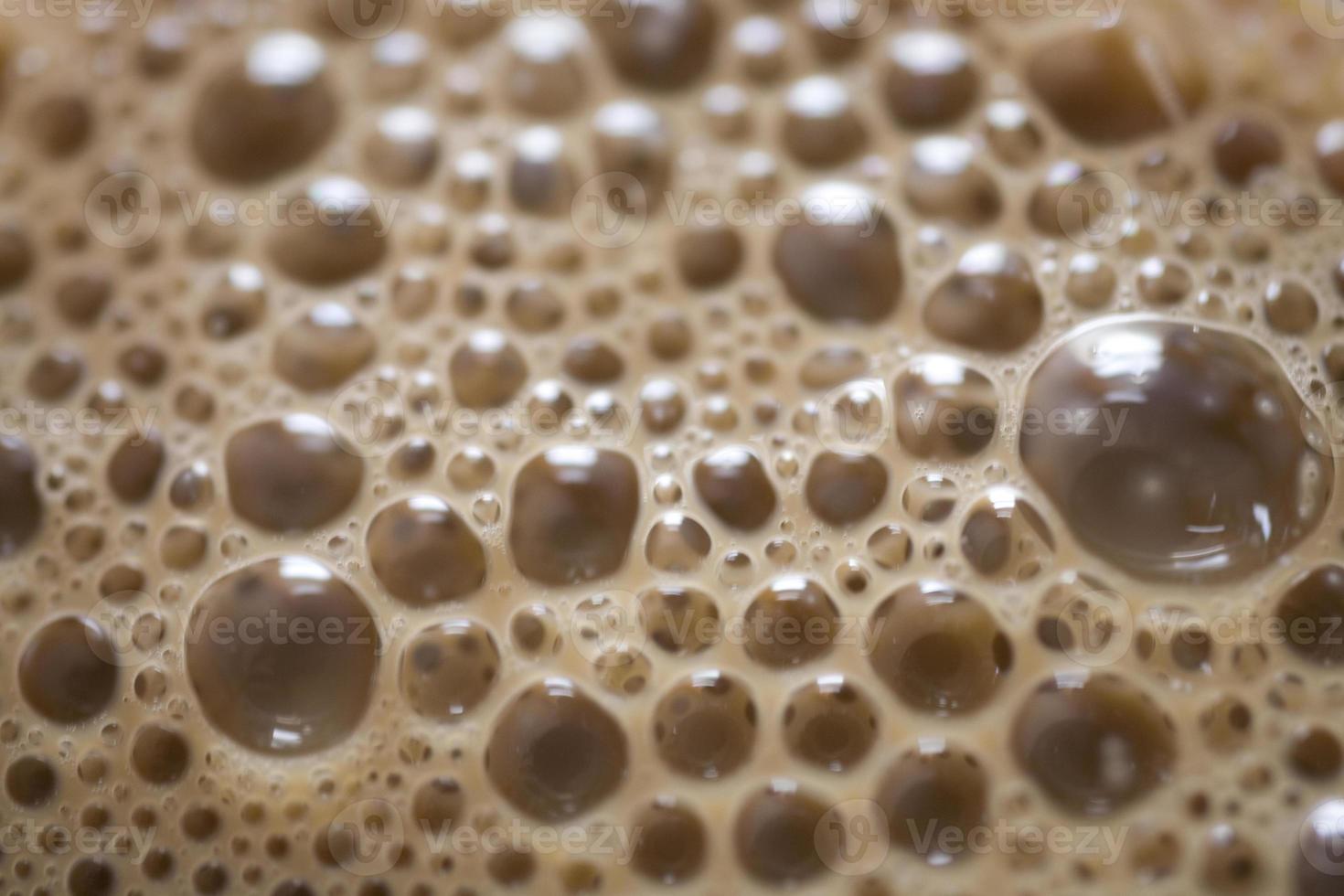 background of beige coffee foam in closeup photo