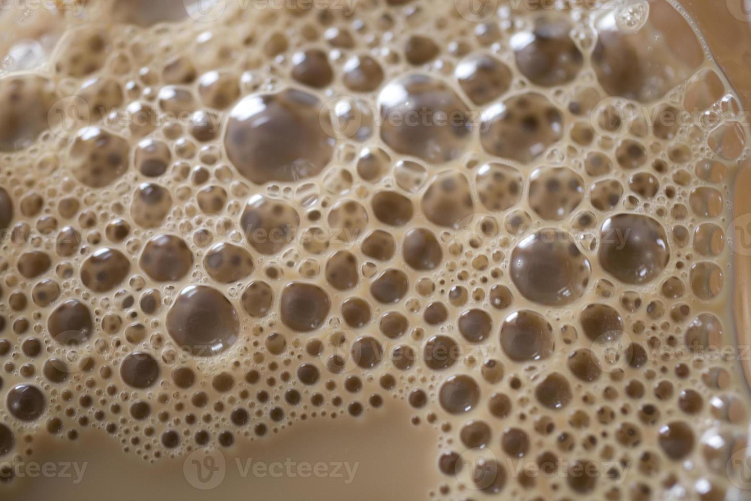 background of beige coffee foam in closeup photo