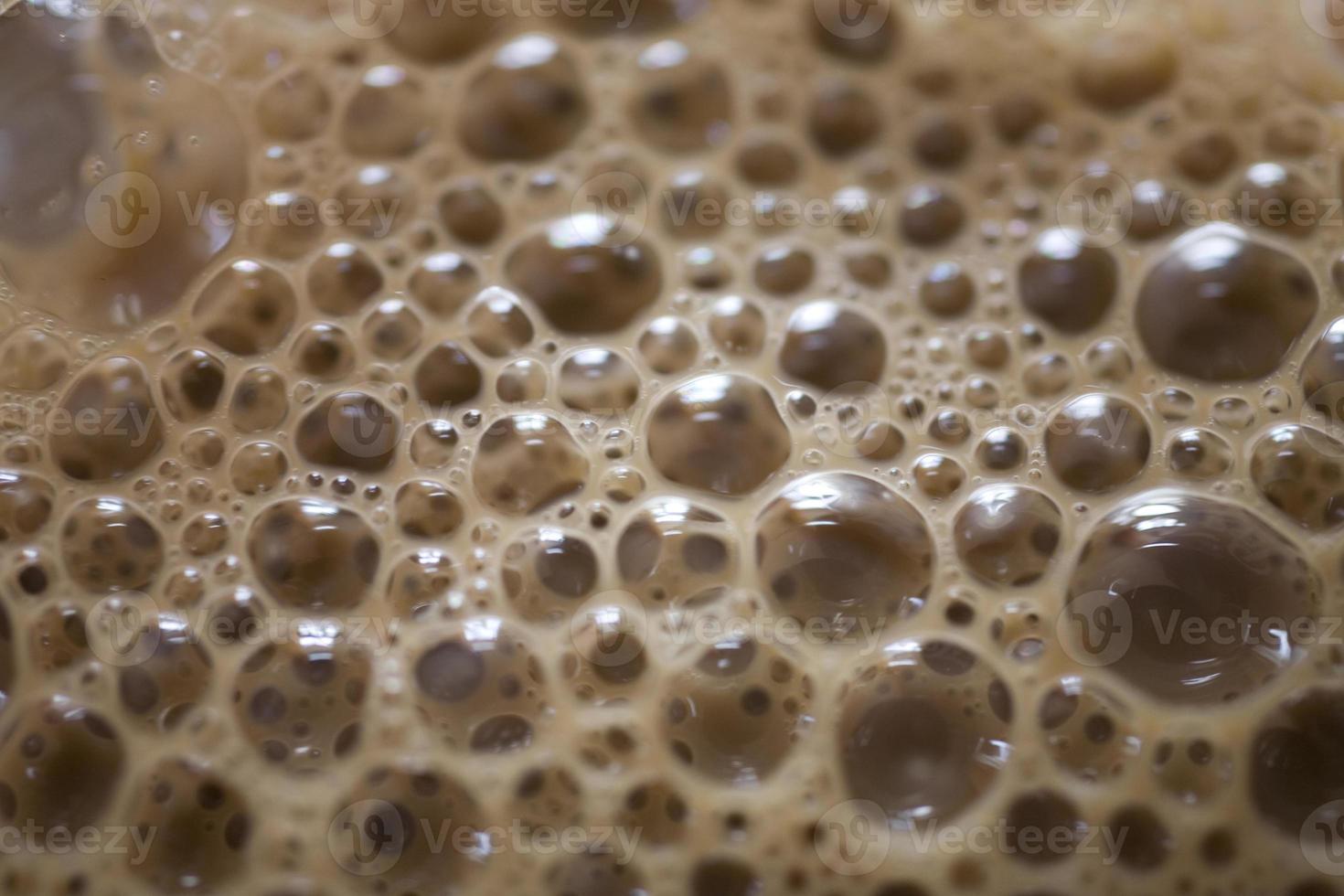 background of beige coffee foam in closeup photo