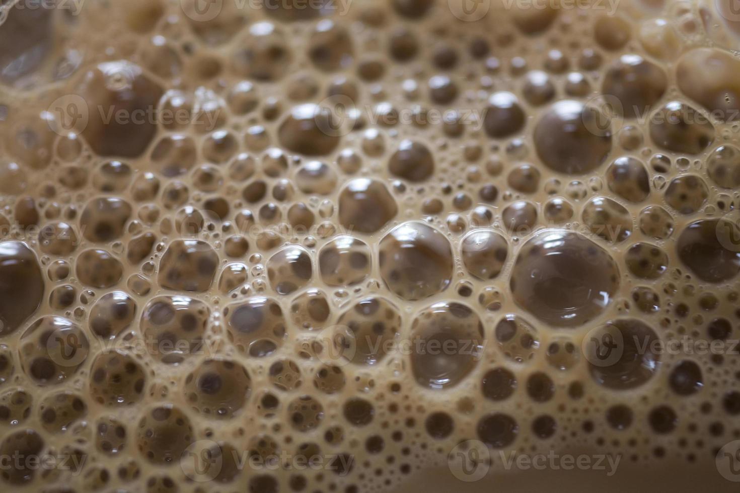 background of beige coffee foam in closeup photo