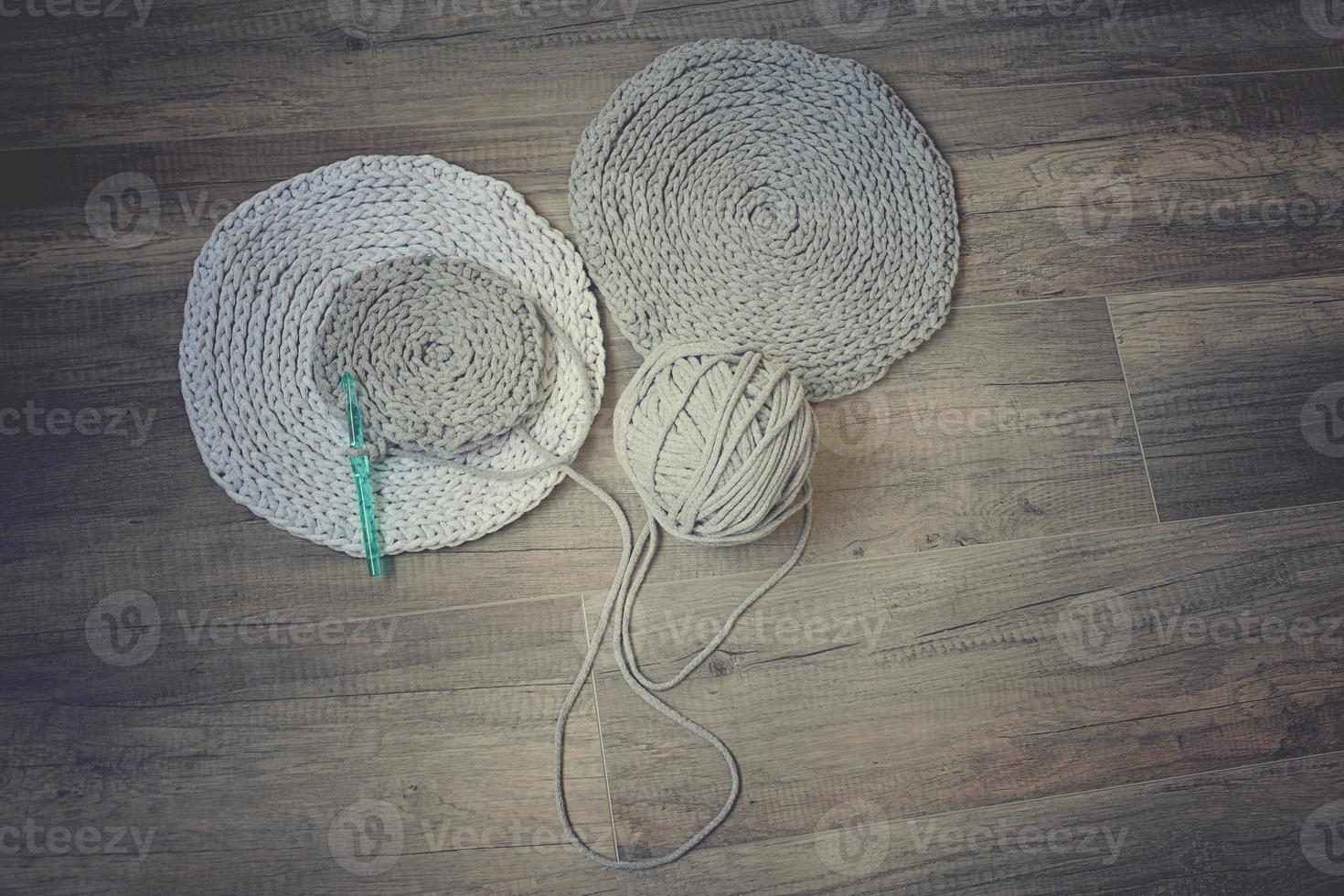 grey handmade cottoncord tablecloths on crochet hook photo