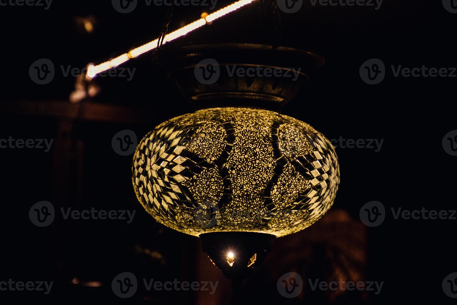 original oriental lamp shining with warm light during the coming dark photo