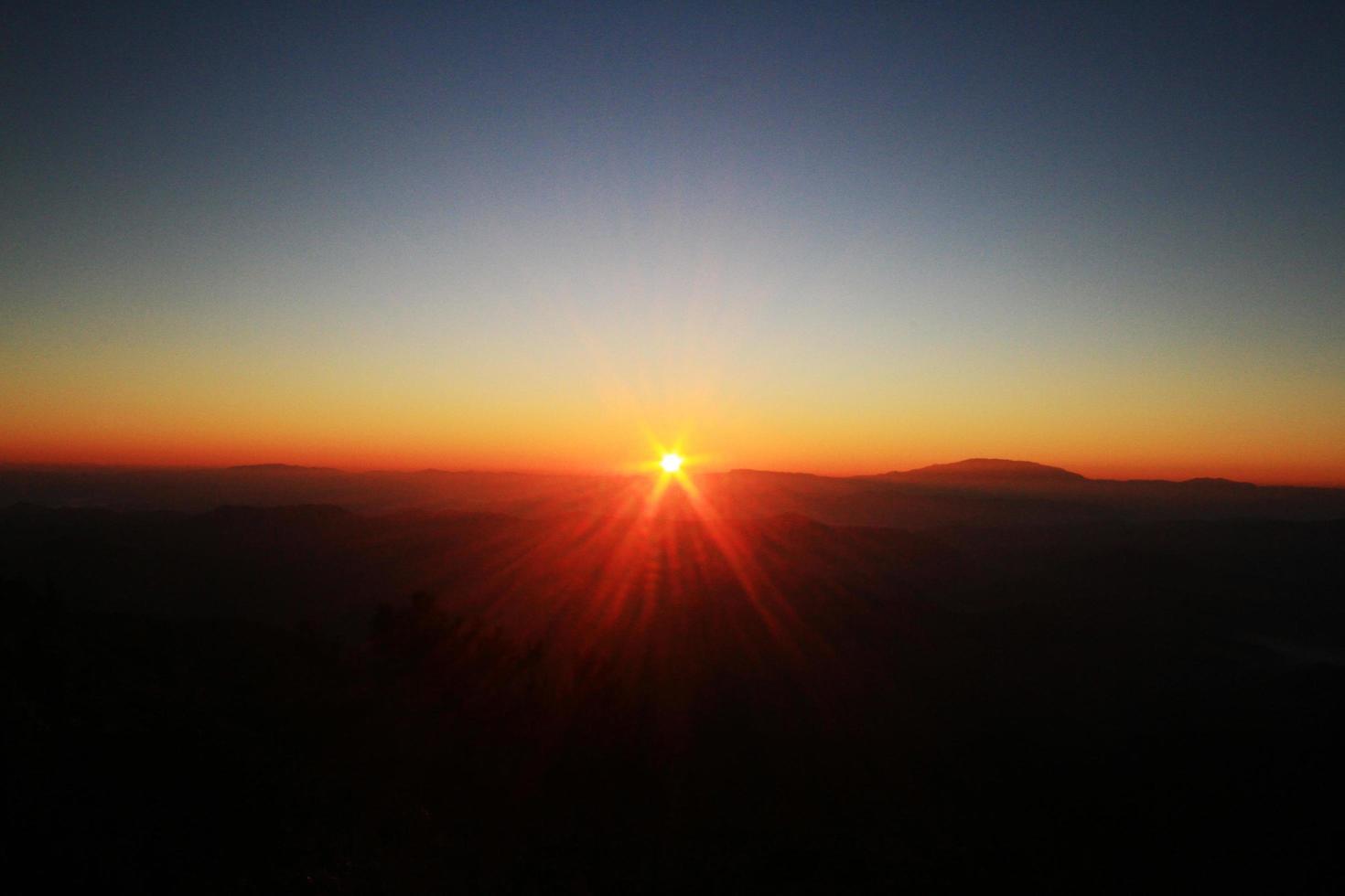 Beautiful golden natural sunlight and twiligh of sunrise shining to in the mist on valley of mountain in Thailand photo