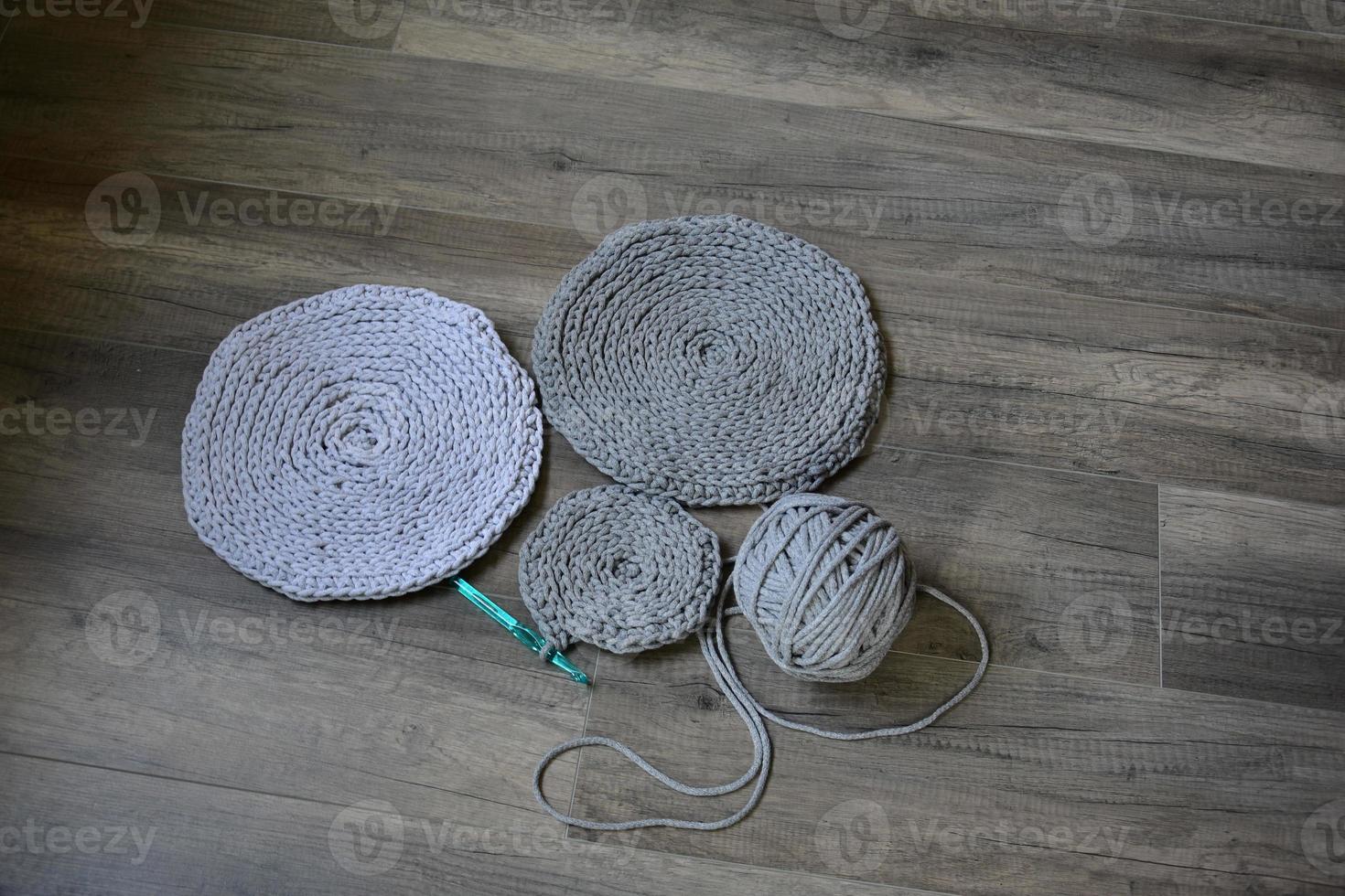 grey handmade cottoncord tablecloths on crochet hook photo