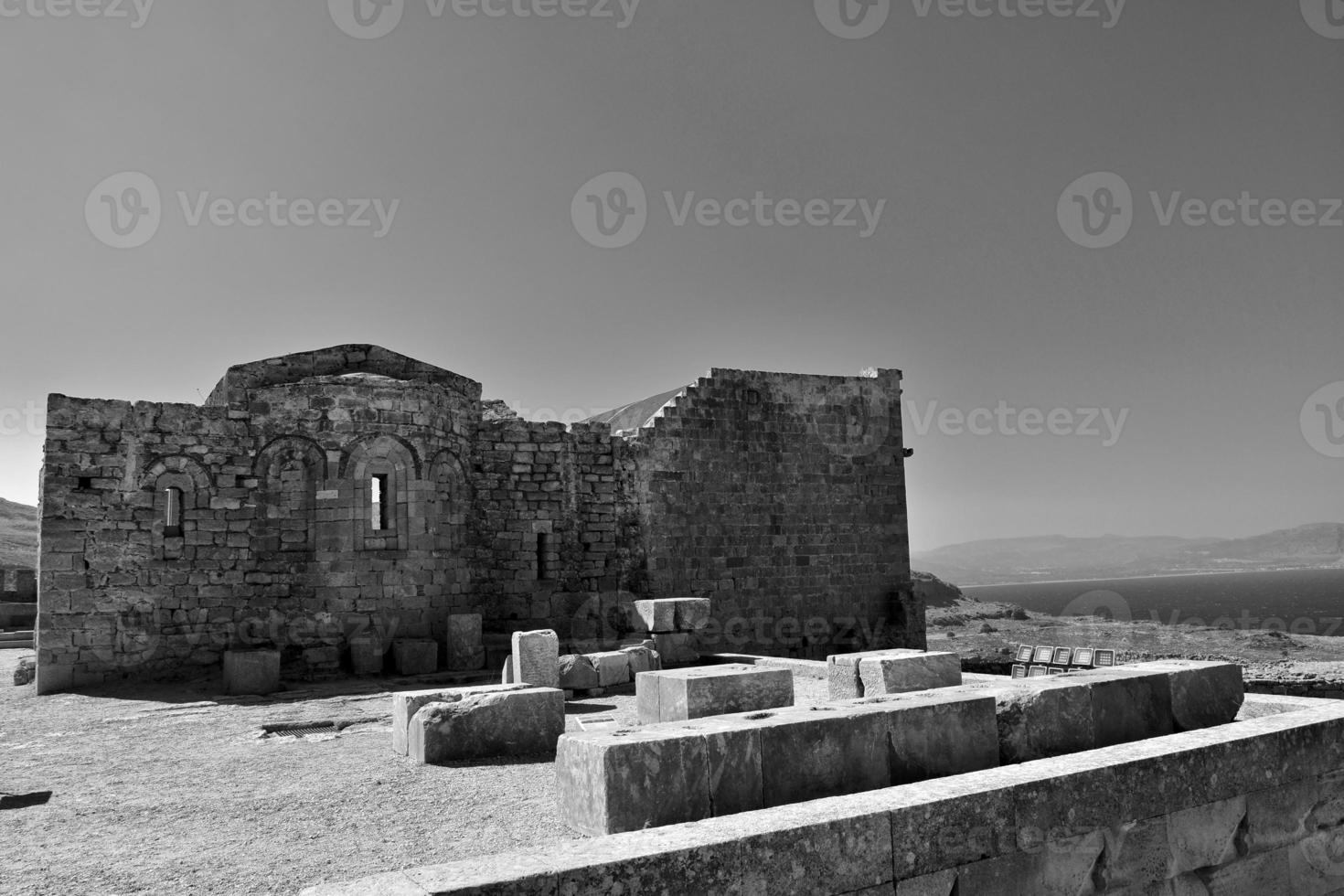 old antique stone ruins on a hot summer day on the Greek island of Rhodes in Lindos photo