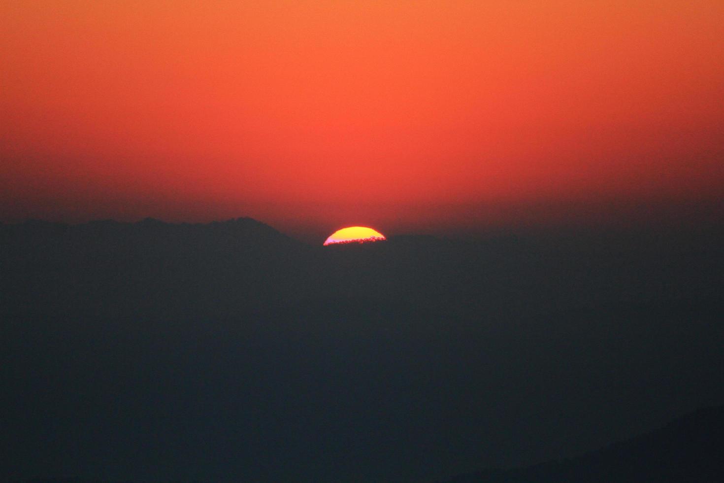 Sunset in sky and cloud, beautiful colorful twilight time with silhouette of mountain. photo