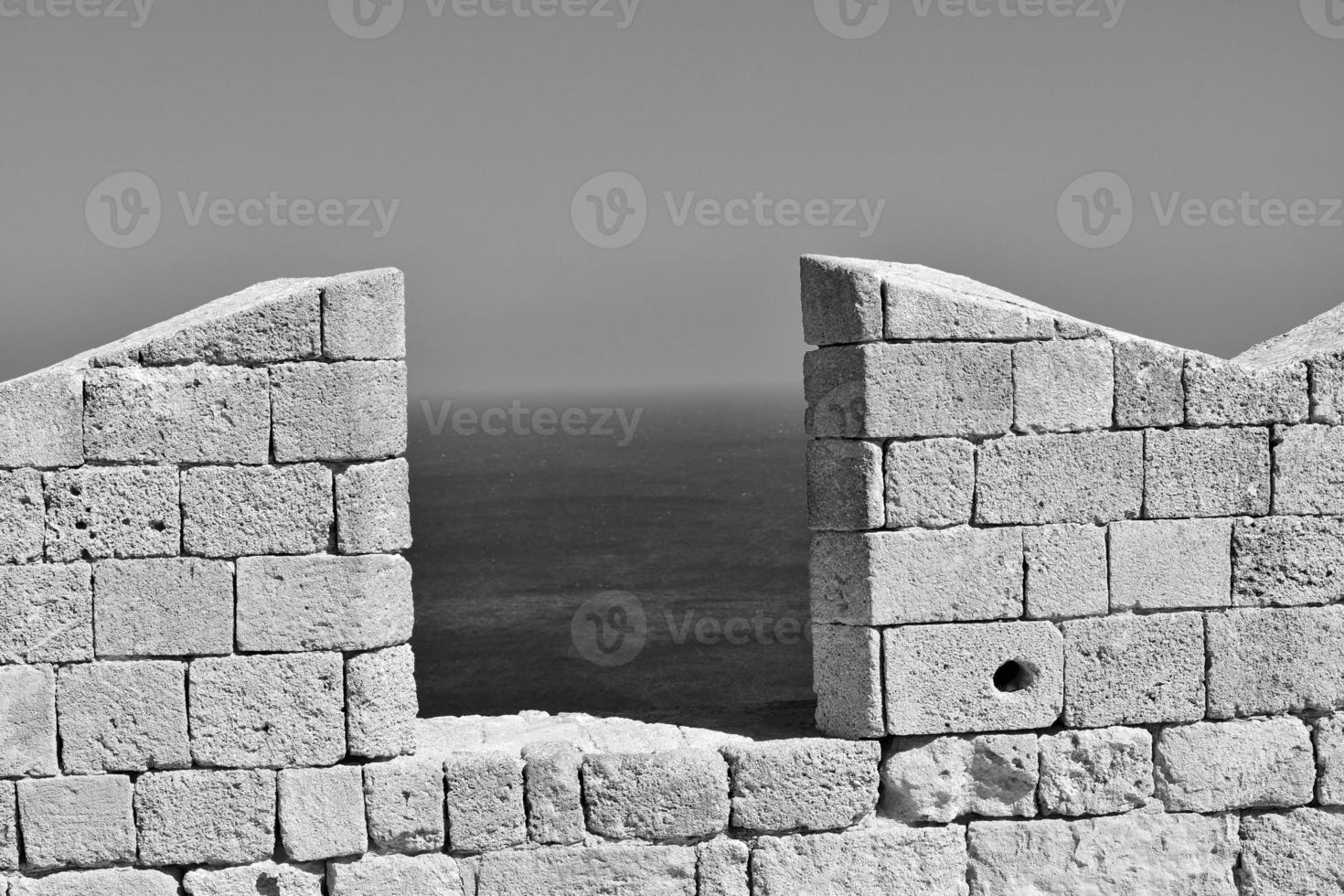 old antique stone ruins on a hot summer day on the Greek island of Rhodes in Lindos photo