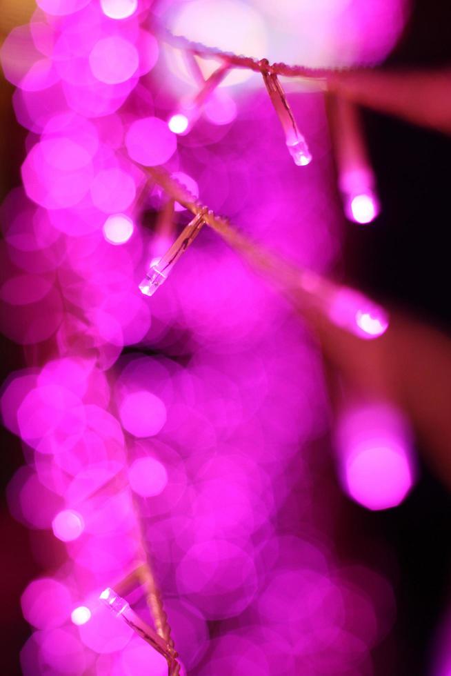 Glamour Ultra Violet sparkling and purple glitter bokeh of metallic circle. Multicolored Christmas and New Year glowing light abstract for Christmas and holiday concept. photo