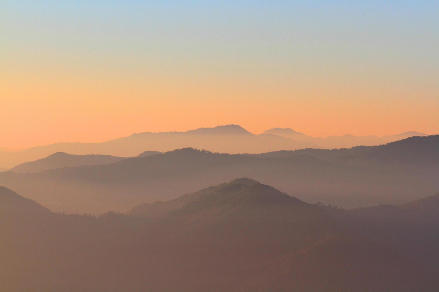 hermosa puesta de sol y amanecer en cielo y dorado crepúsculo hora con niebla y niebla en Valle de montaña capa foto