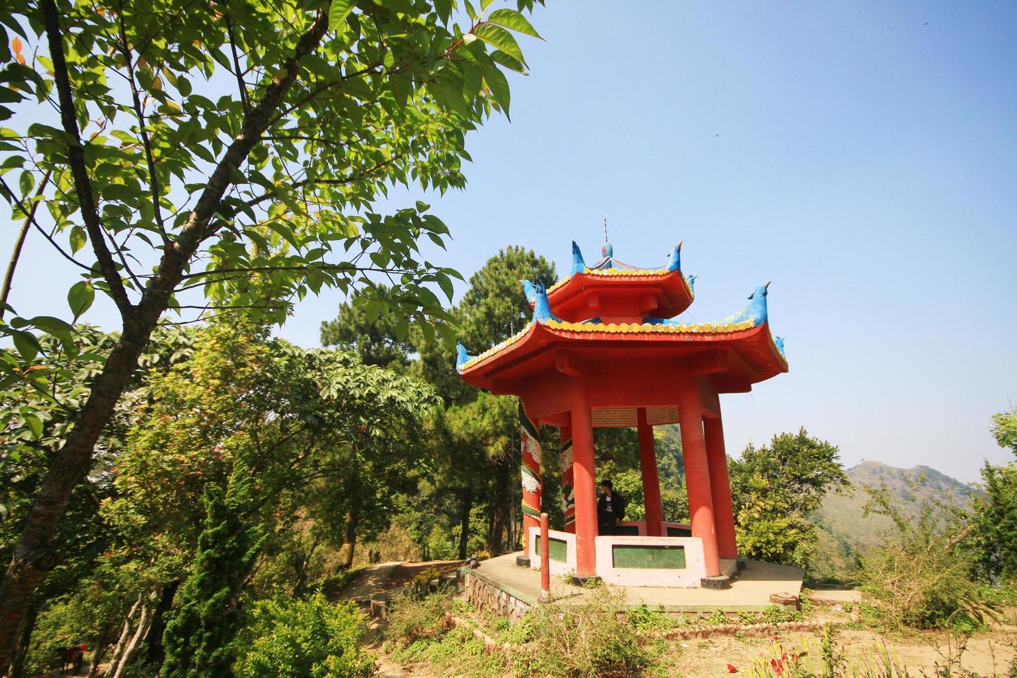 Asian man sitting and relax in Chinese pavilion on Doi Pha Tang mountain. photo