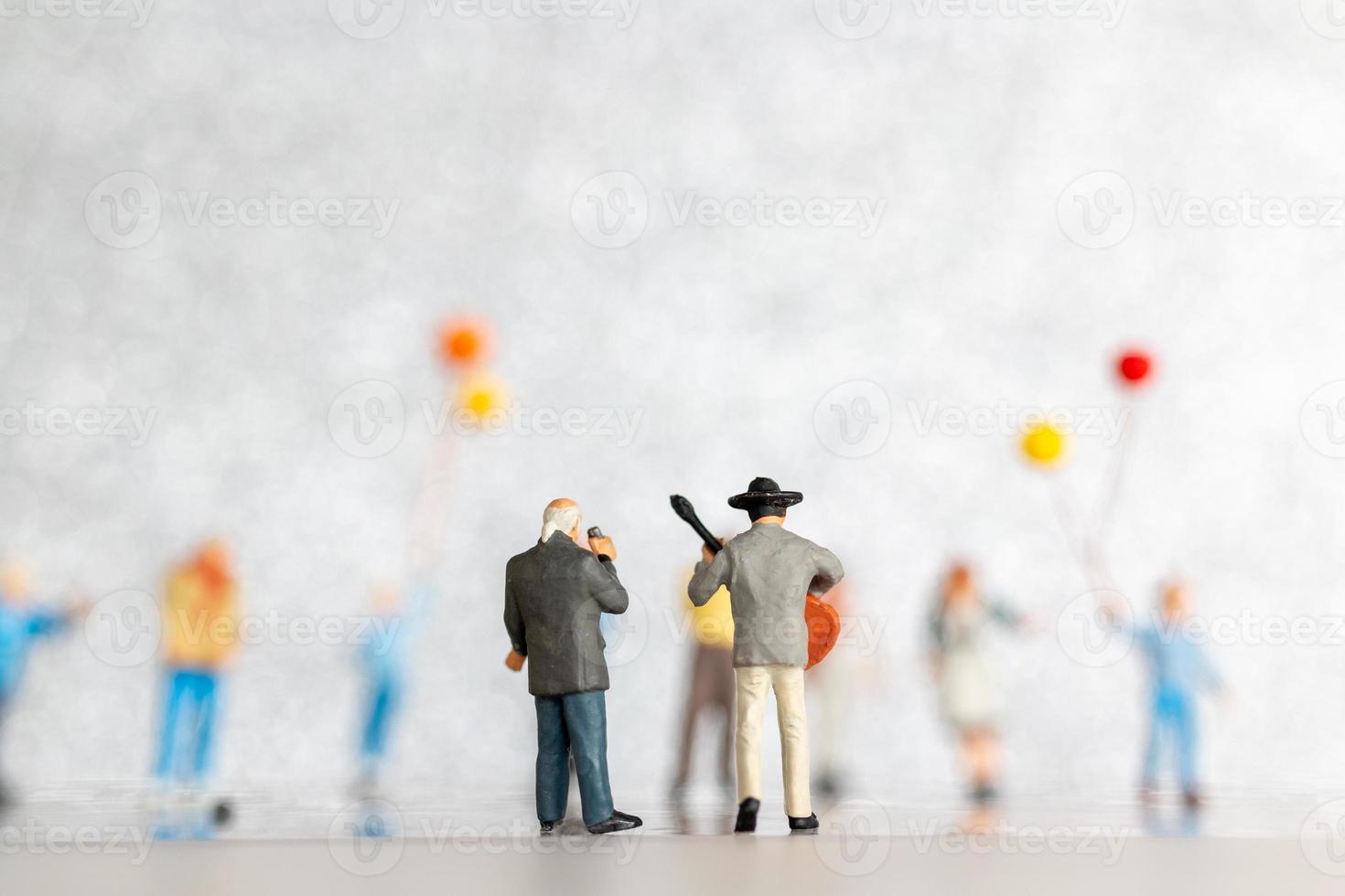 Miniature Singer and Musician playing a guitar on stage, World music day concept photo