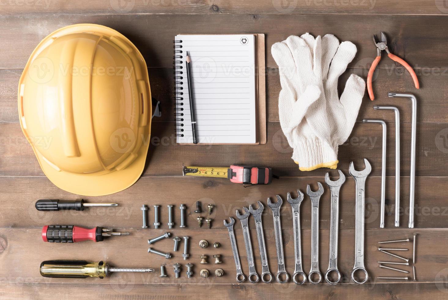 Set tools supplies with blank notebook on wood photo