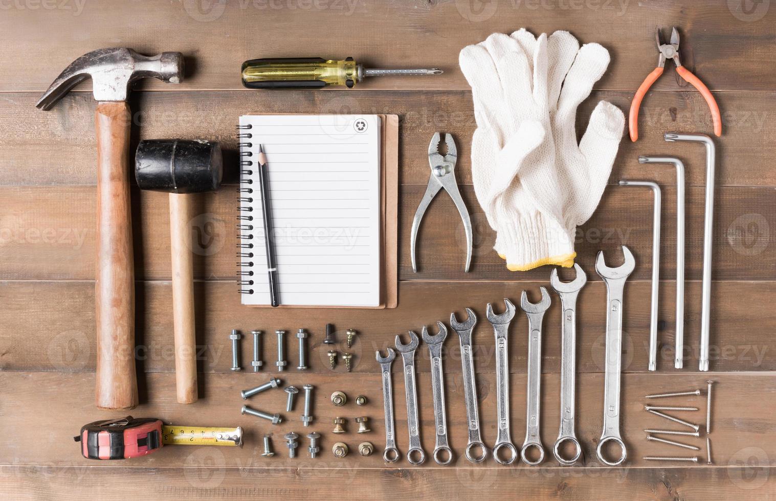 Set tools supplies with blank notebook on wood photo