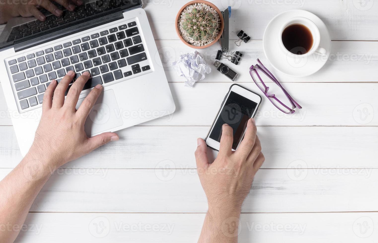 business hand man using computer and mobile phone photo