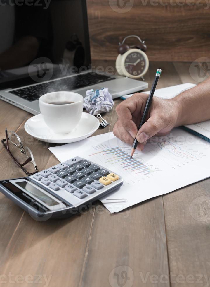 Unrecognizable business person analyzing graphs photo