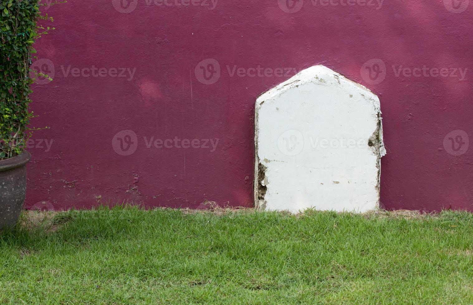 old white cemetery sign on the green lawn photo