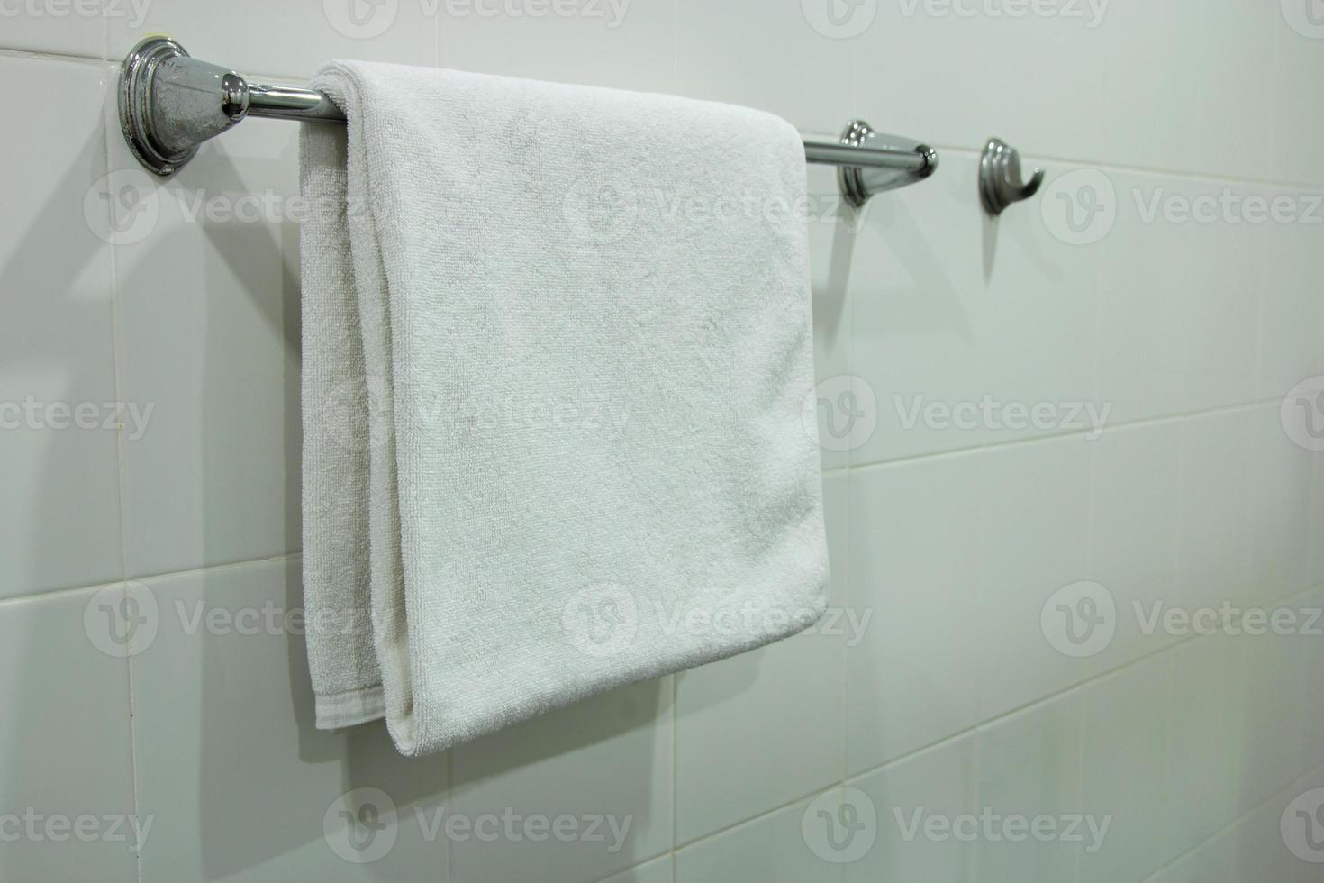 White Bath Towel Hanging on the Bathroom photo