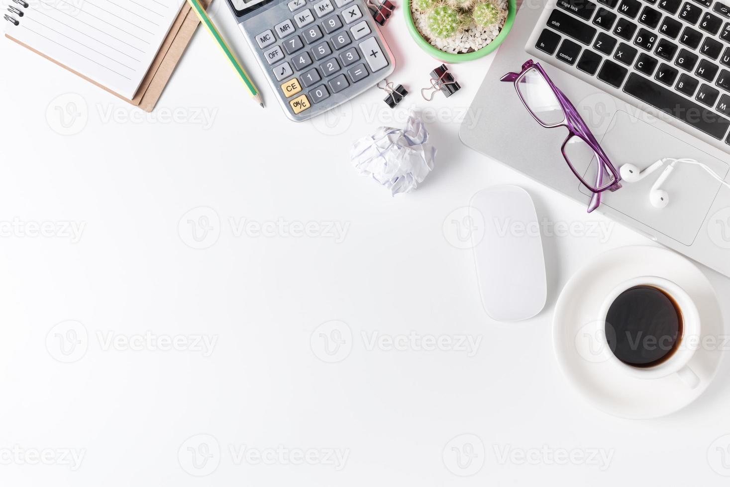 Modern white office desk table with laptop, mouse and other supplies. photo
