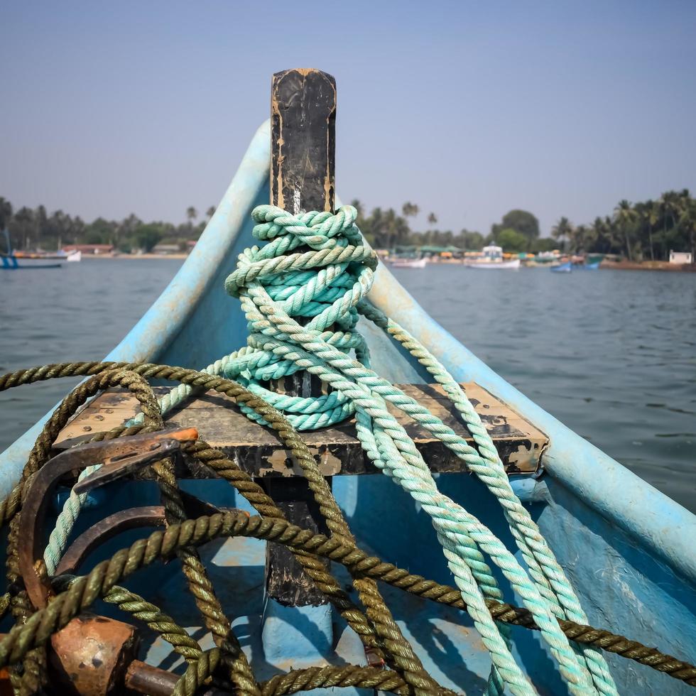 Amazing view from over long tail motor boat in Arabian sea in Goa, India, Ocean view from wooden boat with old ropes photo