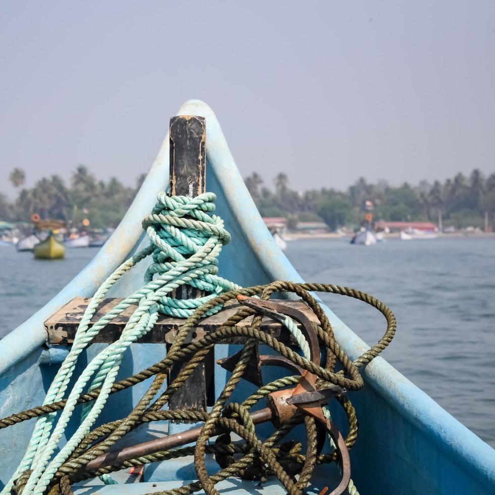 Amazing view from over long tail motor boat in Arabian sea in Goa, India, Ocean view from wooden boat with old ropes photo
