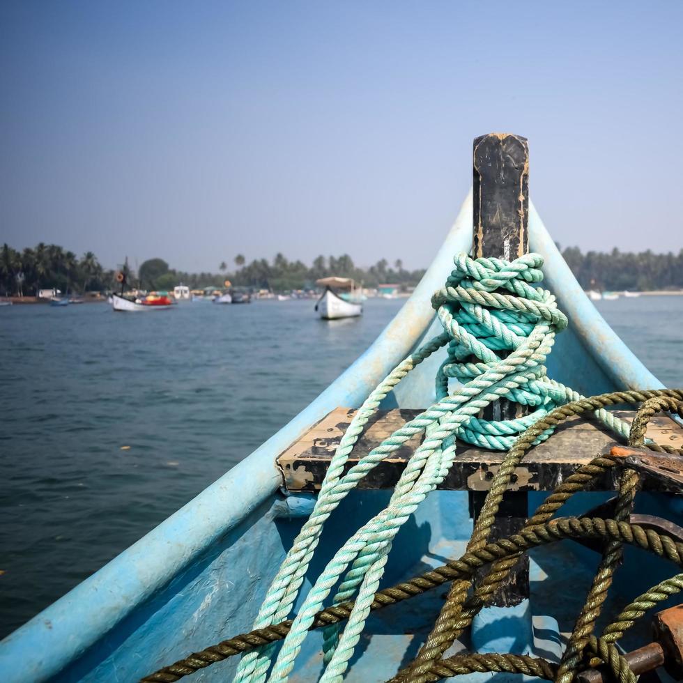 Amazing view from over long tail motor boat in Arabian sea in Goa, India, Ocean view from wooden boat with old ropes photo