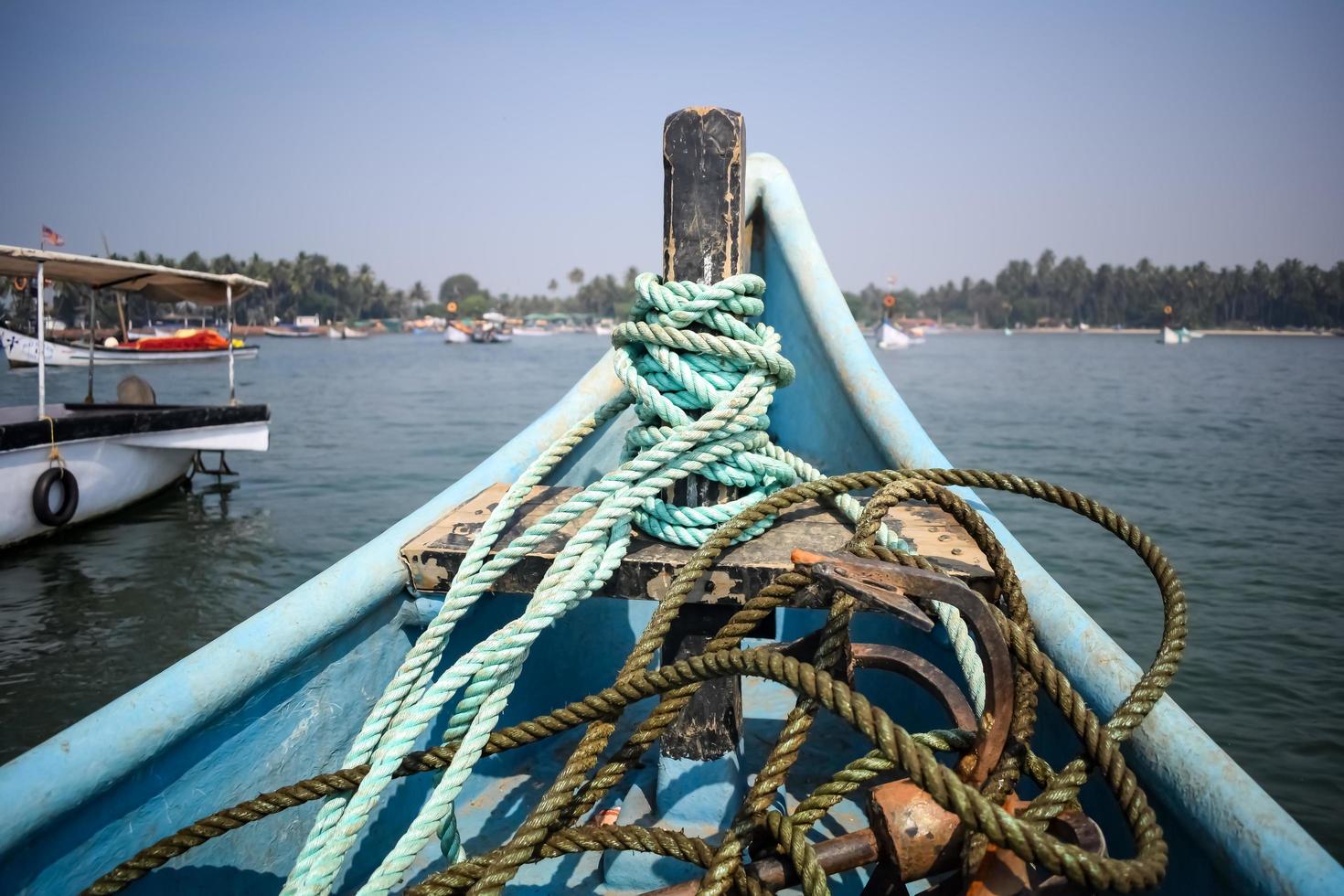 Amazing view from over long tail motor boat in Arabian sea in Goa, India, Ocean view from wooden boat with old ropes photo