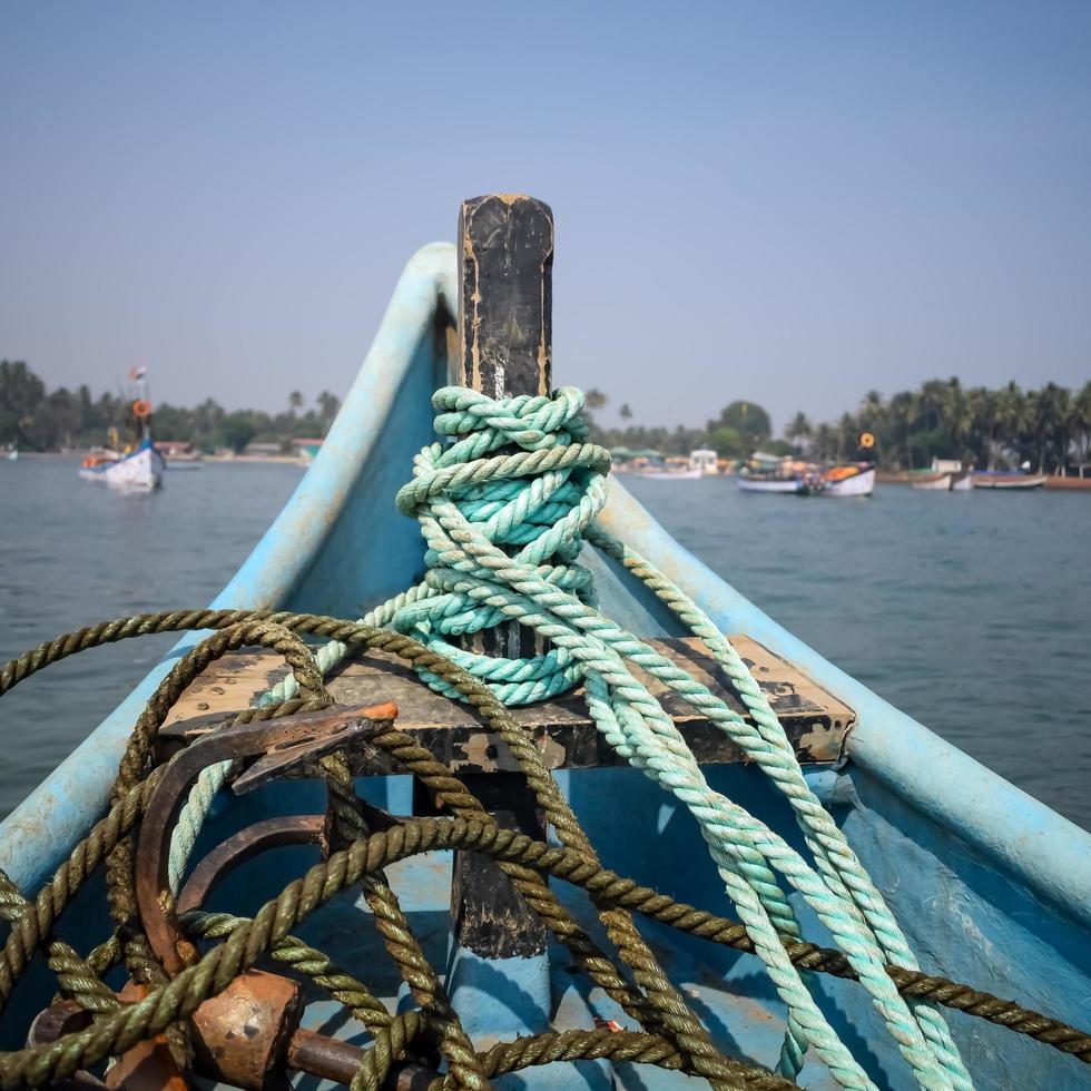Amazing view from over long tail motor boat in Arabian sea in Goa, India, Ocean view from wooden boat with old ropes photo