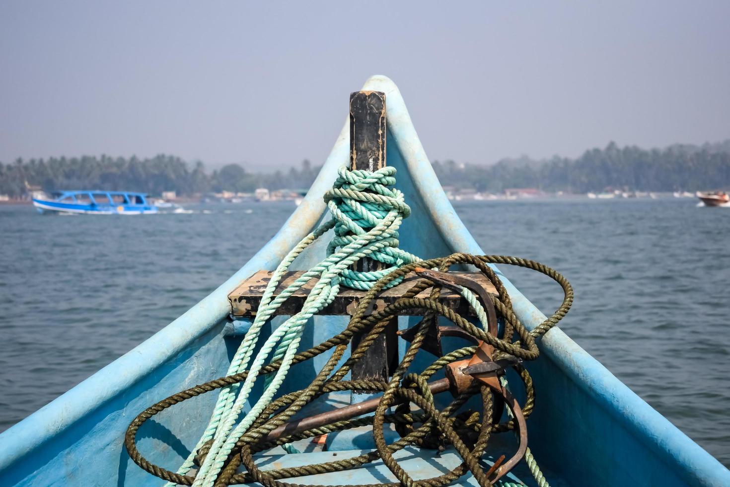 Amazing view from over long tail motor boat in Arabian sea in Goa, India, Ocean view from wooden boat with old ropes photo